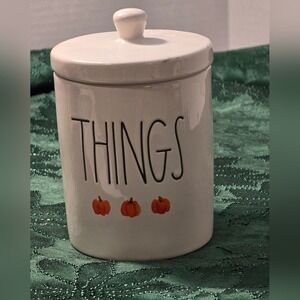 Rae Dunn Cream Jar with Orange Pumpkin Accents with 'THINGS'‎ text.